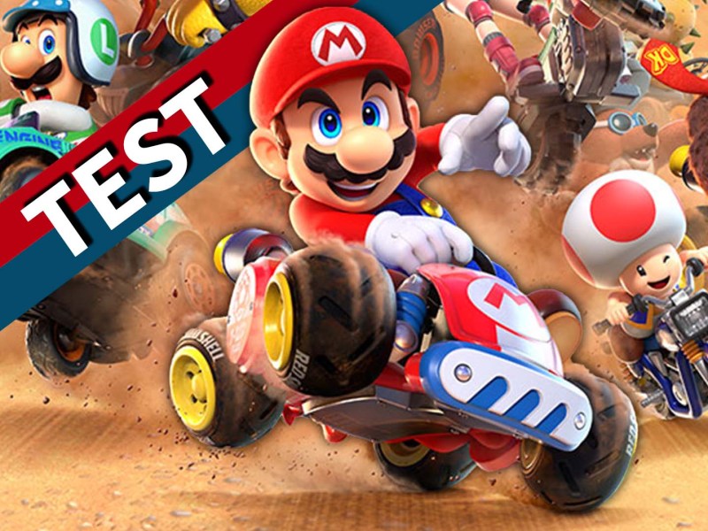 Eine Collage aus Mario Kart World und einem rot-blauen Banner mit dem weißen Wort Test darauf.